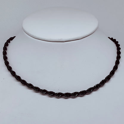 Midnight Steel: 4mm Black Enamel Rope Necklace displayed on a white bust, showcasing its elegant twist design.