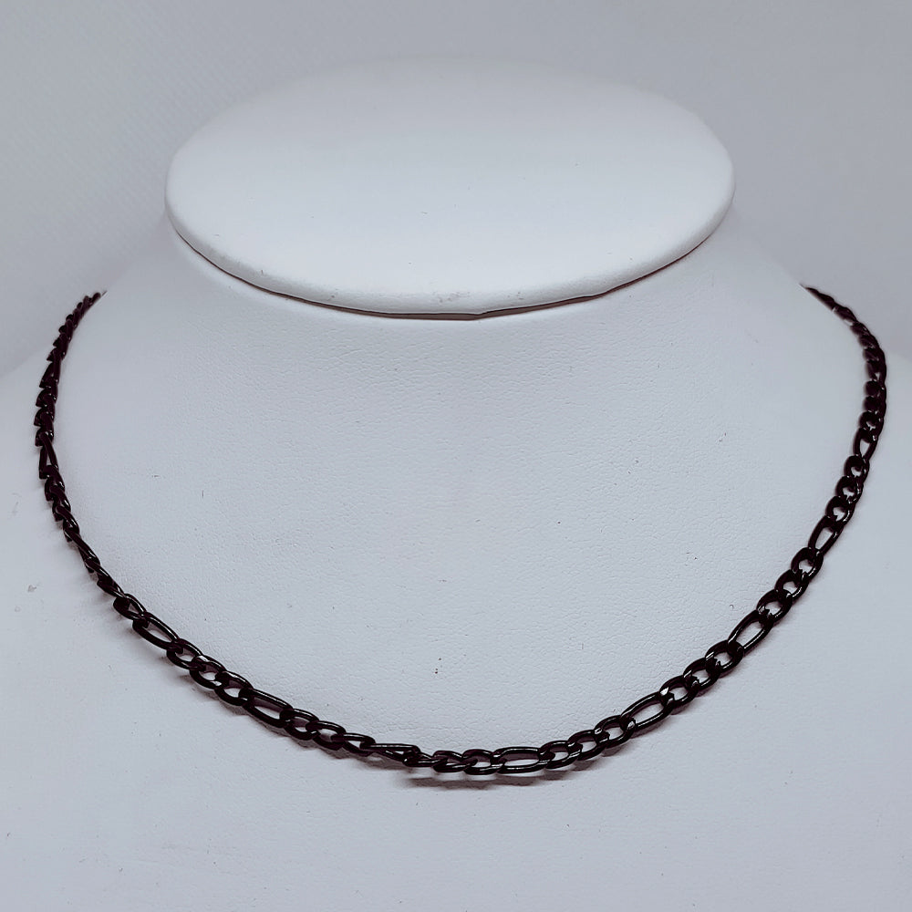 4mm Black Figaro Chain Necklace – Durable Enamel-Coated Stainless Steel displayed on a jewelry stand