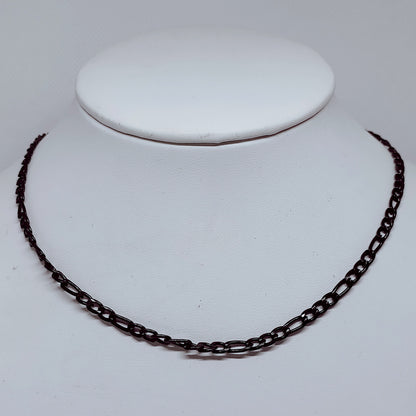 4mm Black Figaro Chain Necklace – Durable Enamel-Coated Stainless Steel displayed on a jewelry stand