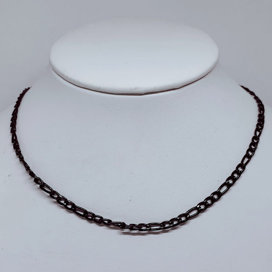 4mm Black Figaro Chain Necklace – Durable Enamel-Coated Stainless Steel displayed on a jewelry stand